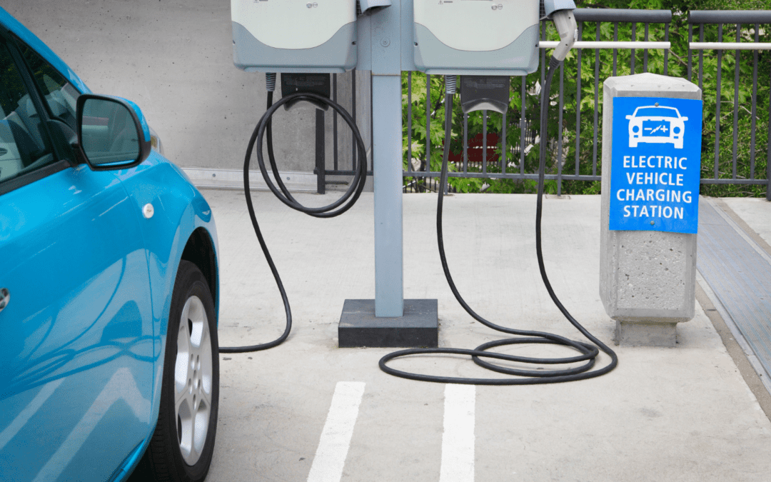 blue car using level 1 ev charger in orange county