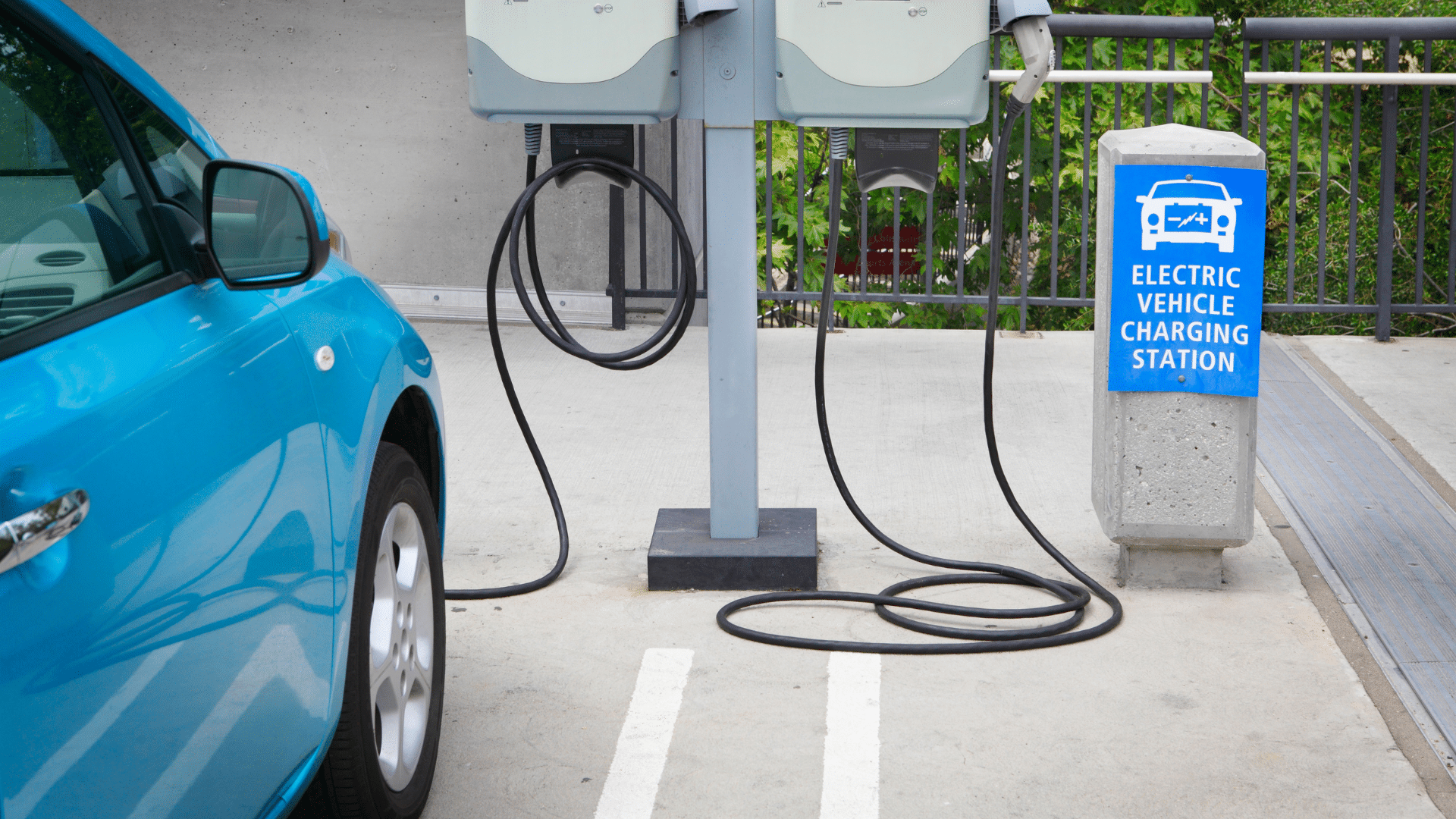 blue electric vehicle charging at a free EV charging station in Orange County