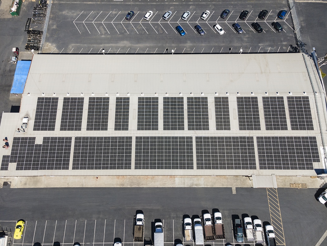 overhead shot of a car dealership with solar panels on the roof