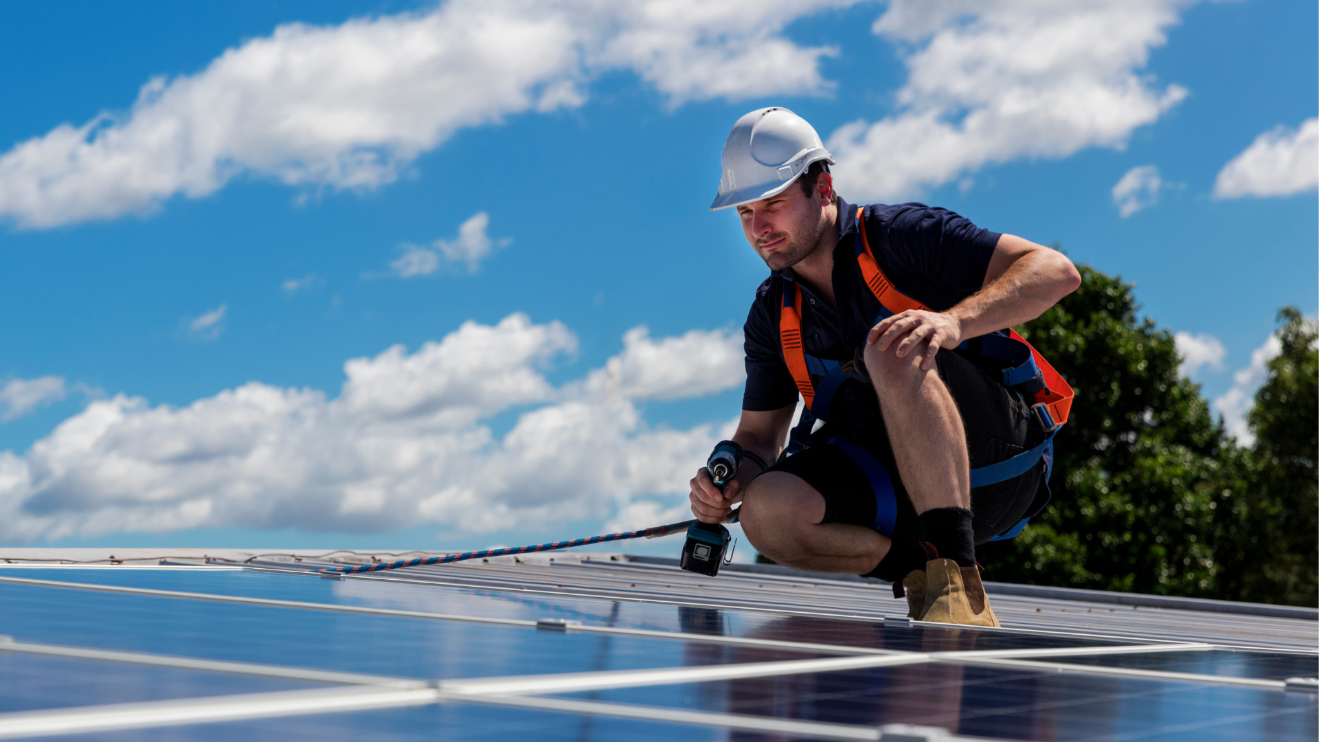 orange county commercial solar panel installer squatting on roof