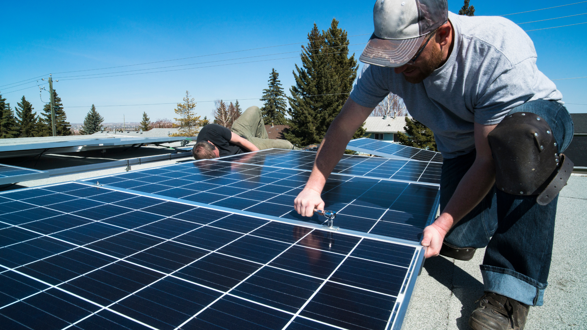 solar installer putting solar panels on new roof in orange county