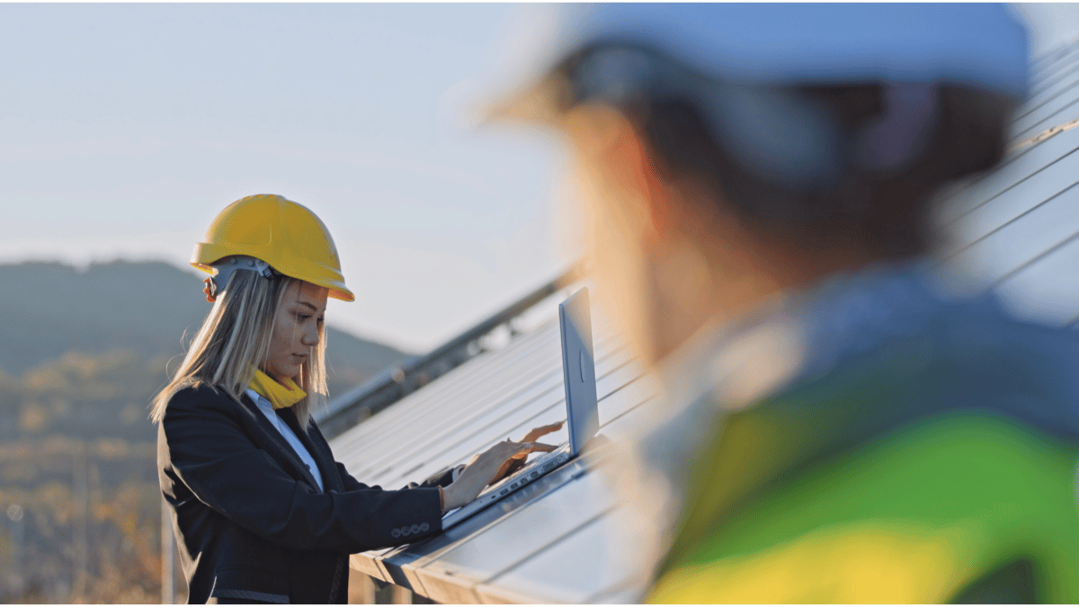female solar panel installer working on commercial orange county solar installation