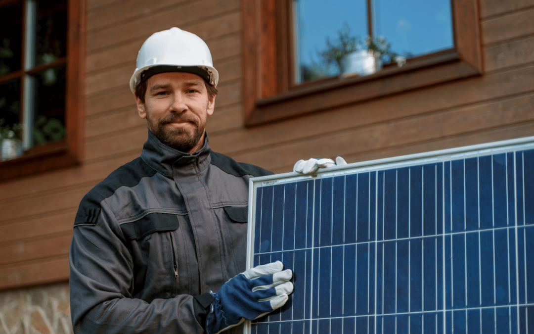 solar panel technician in orange county holding a solar panel